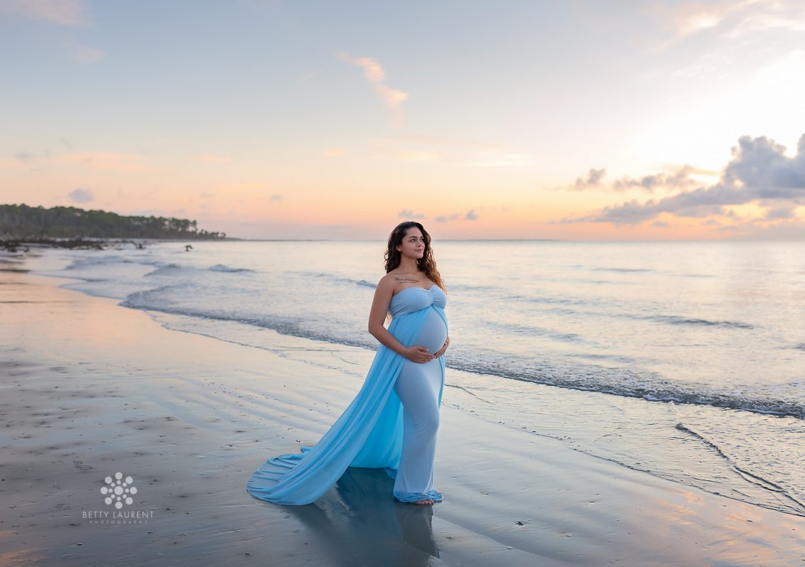 blue dress mom at the beach at sunrise peach colored sky