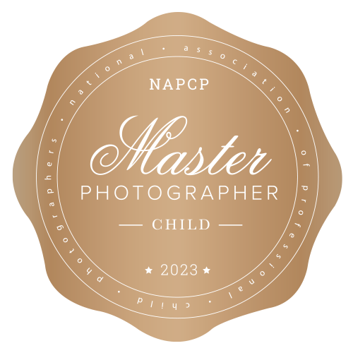 Featured Award Badge, A gold Seal reads "NAPCP Master Photographer [for] Child 2023"