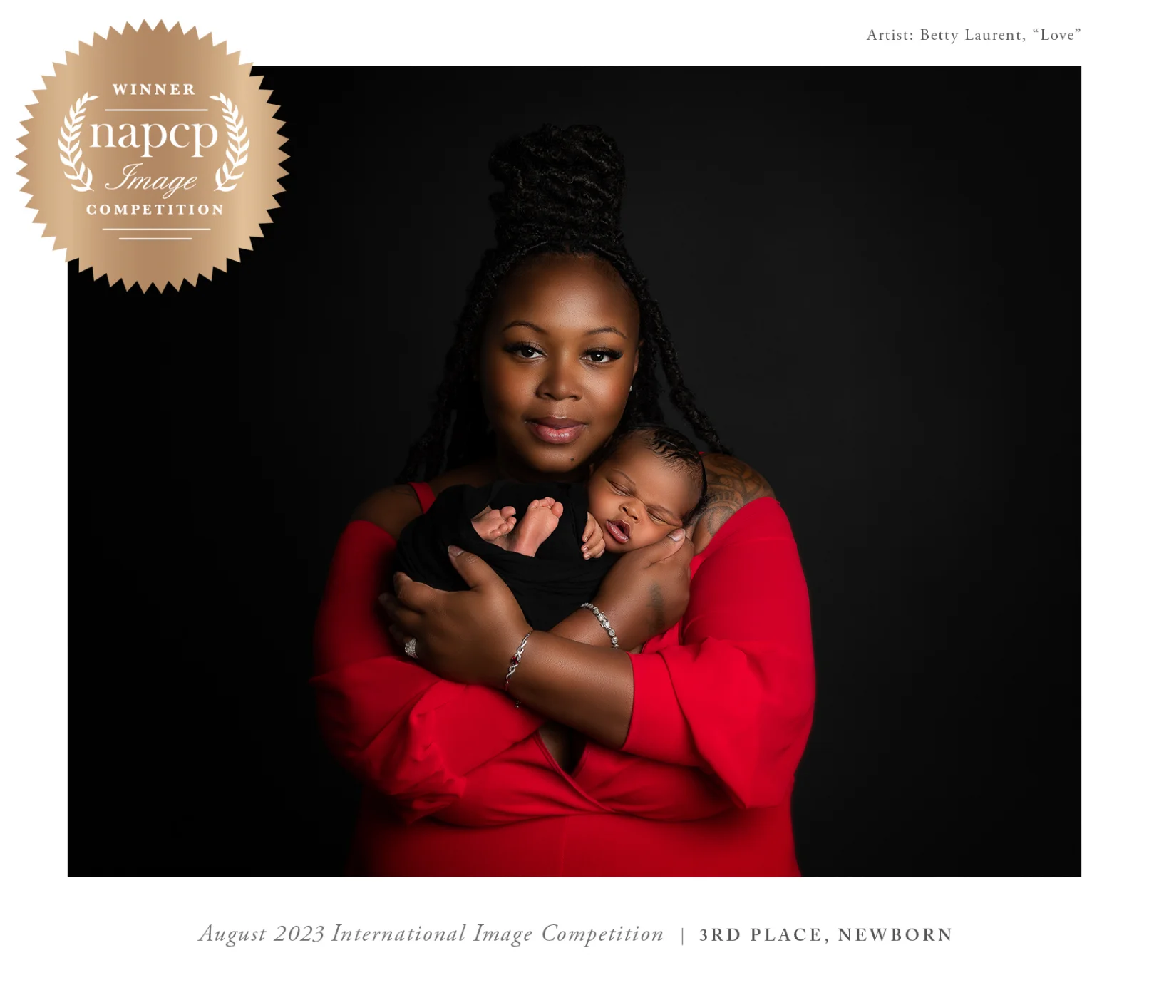 Newborn Photographer, a mother holds her little baby close to her chest, she wears red, a NAPCP "winner" badge sits atop the portrait